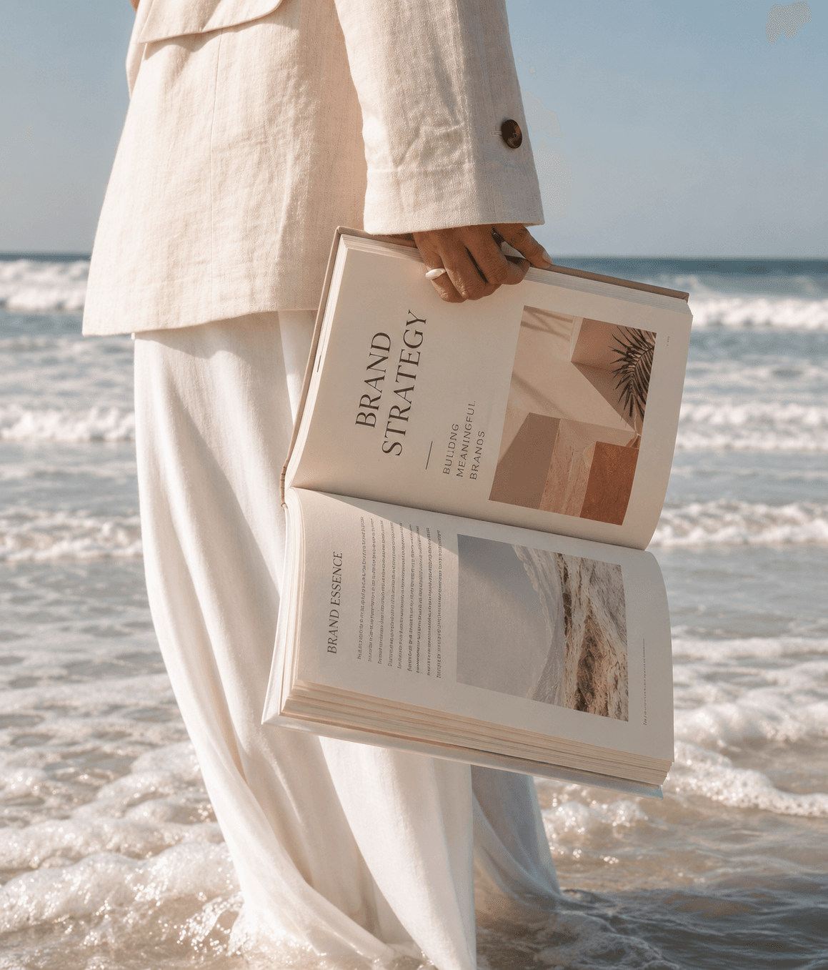 Open brand strategy book held at the water’s edge
